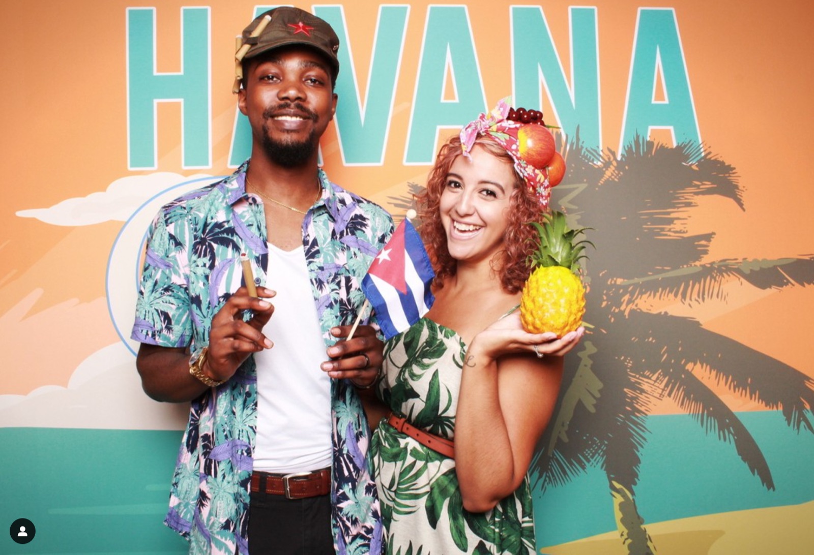 Guests at a custom Havana-themed photo booth backdrop by TBD Photo Booths