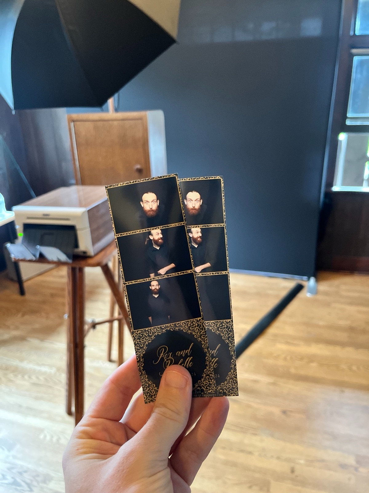 Guests collecting freshly printed photo strips at an event