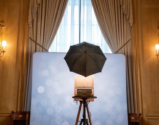 The booth set up against a bokeh backdrop in a grand ballroom